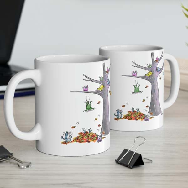 cats jumping in leaves mug